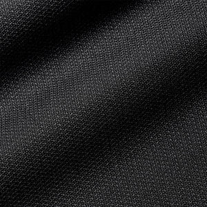 Close-up of the black fabric on a Nike Academy Duffel Bag, featuring a fine, textured weave characteristic of official soccer gear.