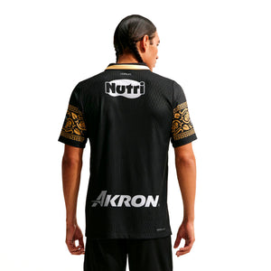 Back view of a Nike Chivas 26/27 Match Third Autenthic Jersey, featuring gold patterned sleeves, a black and white collar, and the words Nutri and Akron printed in white.