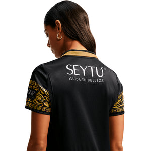Back view of a black Nike Chivas 26/27 Stadium Third Jersey with gold trim on the collar and sleeves, featuring a white SEYTU logo and CUIDA TU BELLEZA text.