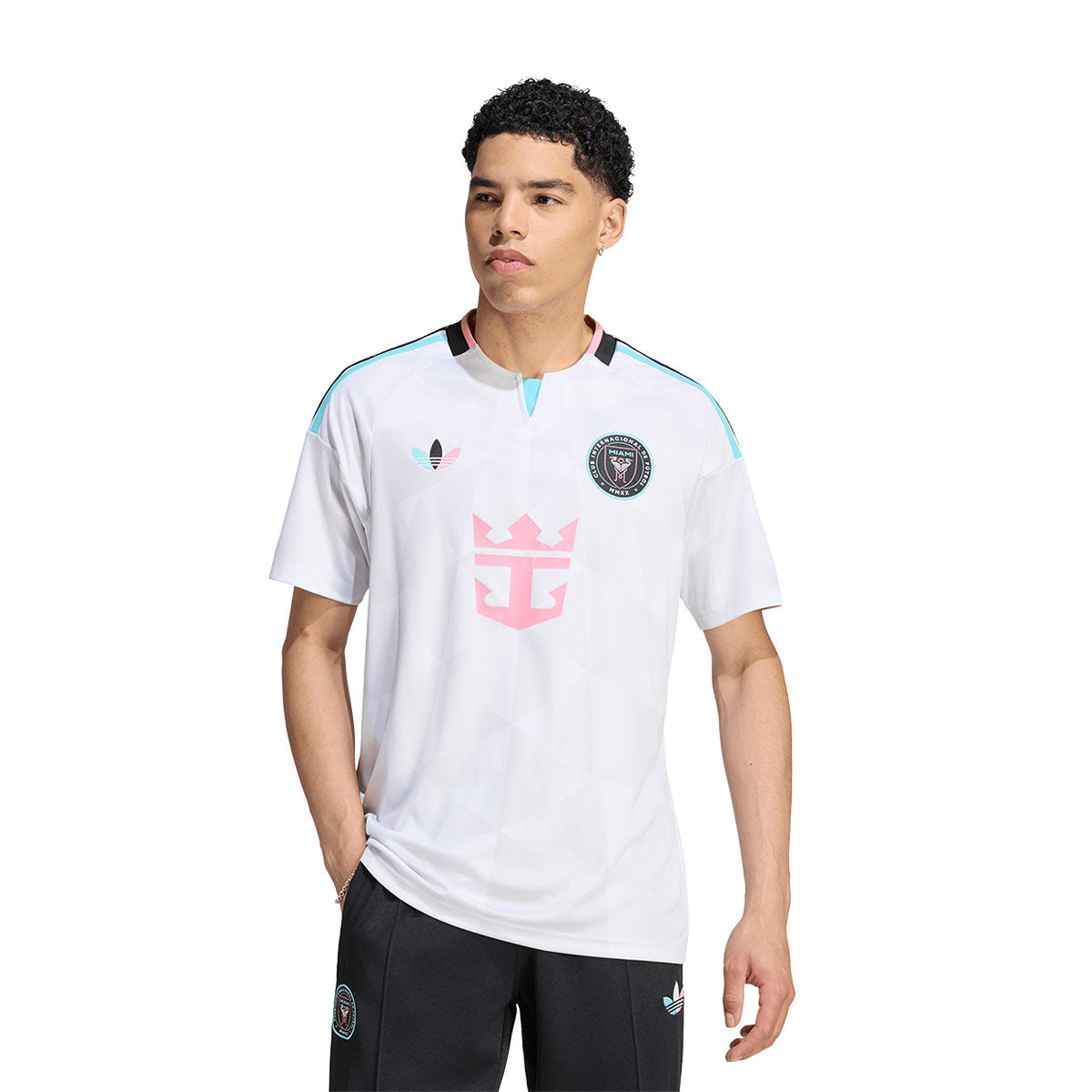 A man wears an adidas Inter Miami CF 2026 Third Jersey featuring light blue shoulder stripes, a pink logo on the chest, and team and brand emblems on the upper chest.