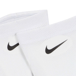 A pair of white Nike Nike Guard Lock Elite Sleeves featuring black swoosh logos, designed to complete an official soccer game-day look.