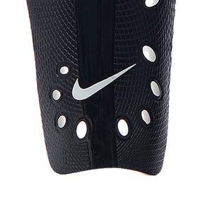 Black Nike J Shin Guards with a textured surface, ventilation holes, and a central white swoosh logo.