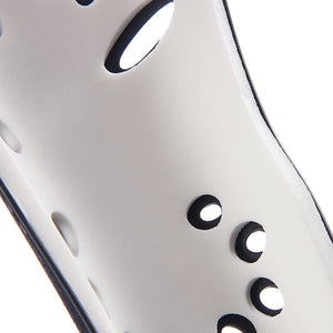 Close-up of Nike J Shin Guards: a white, curved shin guard with ventilation holes.