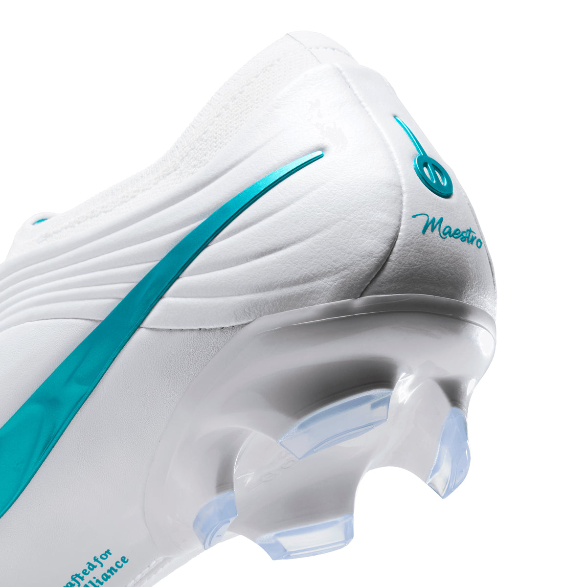 Close-up of the heel of a white Nike Tiempo Maestro Elite Soccer Cleats featuring a teal swoosh, the word Maestro printed on the back, and translucent studs.