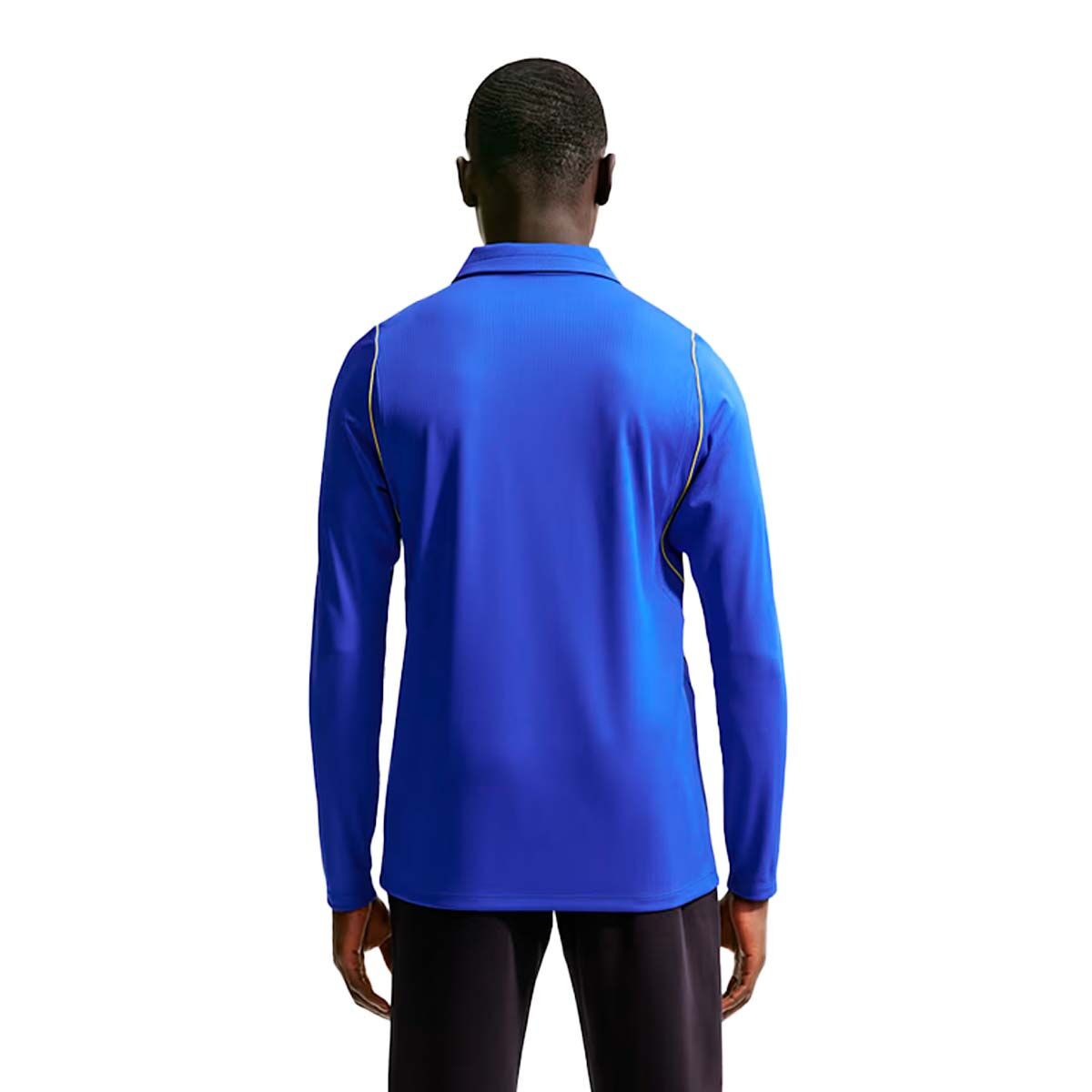 Back view of a person wearing a blue Nike Chelsea FC 26/27 Long Sleeve Stadium Home Jersey, featuring a collar and thin gold trim along the shoulders.