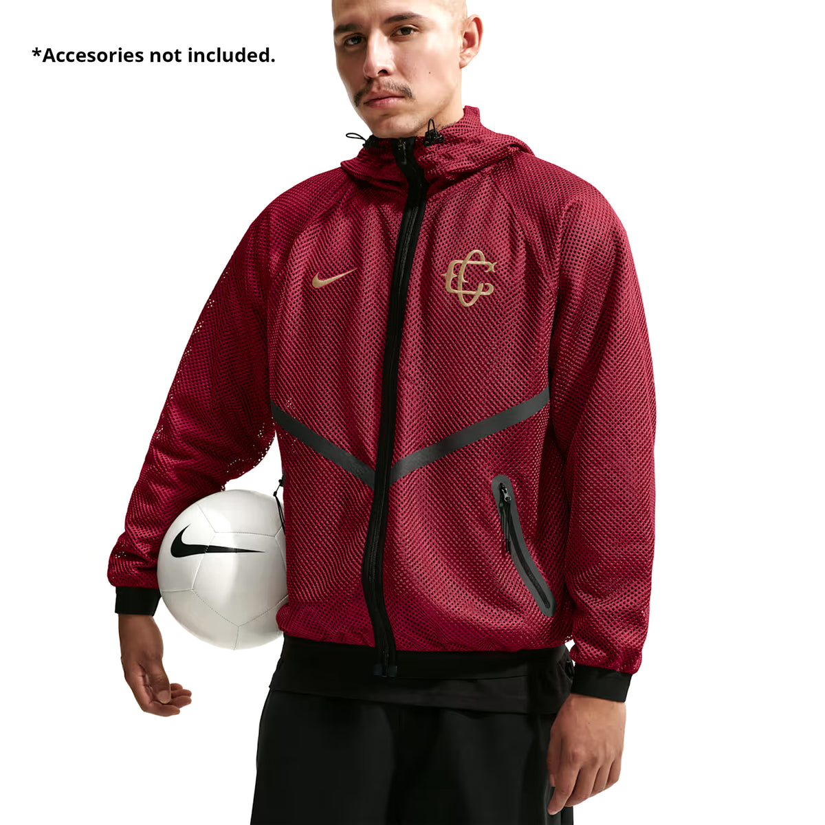A man wearing a burgundy Nike Chivas 26/27 Third Jacket with a gold logo and black hem, holding a white soccer ball. Text on the image reads, Accessories not included.