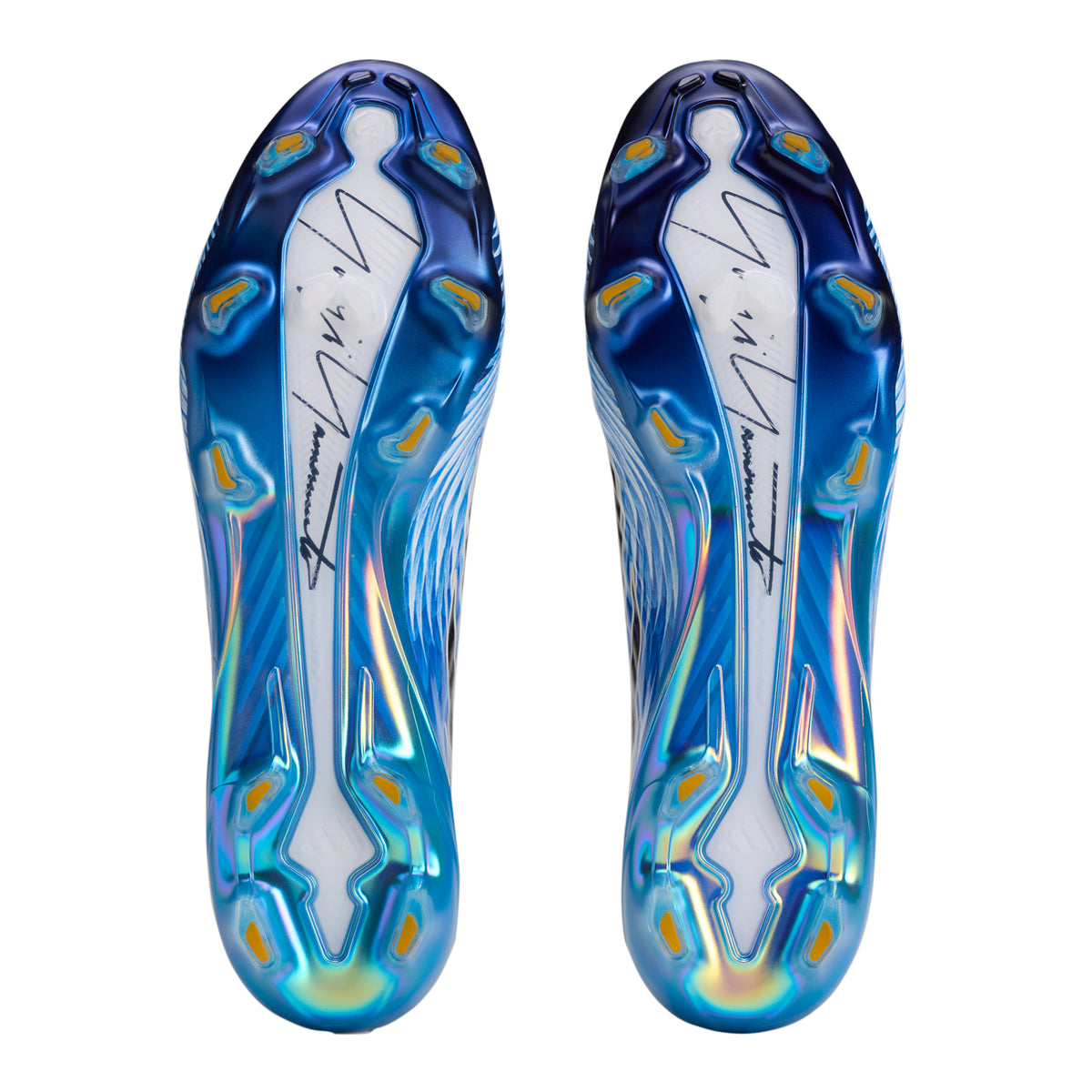 The soles of two adidas F50 Hyperfast Elite Y-3 FG Soccer Cleats, featuring a blue and white iridescent finish with a signature graphic and molded studs.